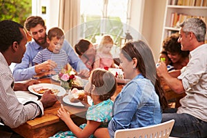 Family and friends sitting at a dining table