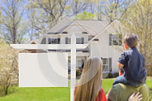 Family in Front of Blank Real Estate Sign and House