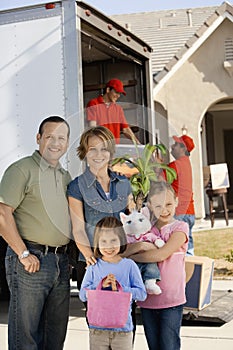 Family In Front Of Delivery Van And House