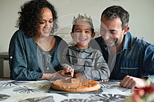 Family in front of a king cake