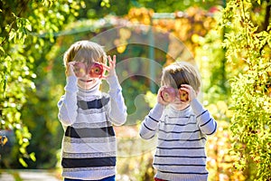 Family fun during harvest time on a farm. Kids playing in autumn garden