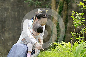 Family fun time, Chinese woman and baby in Hanfu dress enjoy free time