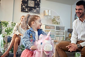 Family Fun Time: Parents and Toddler Daughter Enjoying Playtime