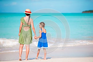 Family fun on white sand. Young mother and adorable kid playing at sandy beach on a sunny day