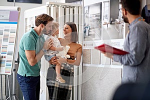 Family furnishing the house. couple choosing household in furniture store photo