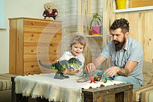 Family game. Child, father and dinosaur. Childrens hobbies. Boy and dad.