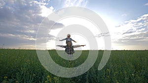 Family game, happy father wears his son on his shoulders during walk on rapeseed field on background sky and sunset
