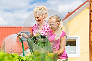 Family at gardening in front of their home