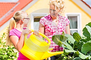 Family gardening in front of their home