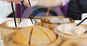 Family gathering in Chinese restaurant, Steamed dim sum basket o