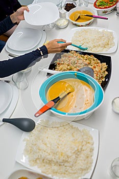 Family gathering eating meal around the kitchen table