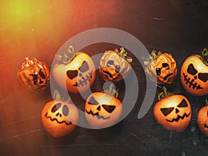 Family generation Halloween concept. Festive still life  pumpkins family on black background with scratches. Top view flat lay