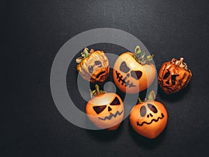 Family generation Halloween concept. Festive still life  pumpkins family on black background. Top view flat lay with copy space