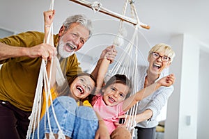 Family, generation love and people concept. Happy grandparent having fun with children at home