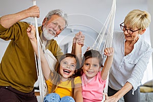 Family, generation love and people concept. Happy grandparent having fun with children at home