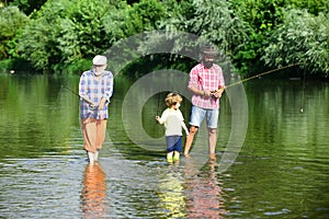 Family generation and people concept. Little boy on a lake with his father and grandfather.