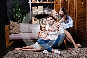 Family with gifts in front of Christmas tree