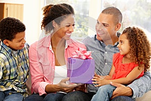 Family giving gift to mother