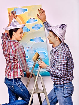 Family glues wallpaper at home