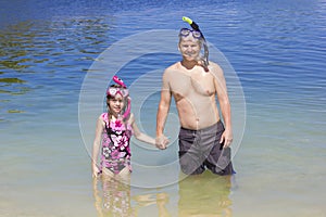 Family going Snorkeling at the Beach on vacation