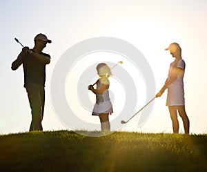 Family of a golfers at sunset