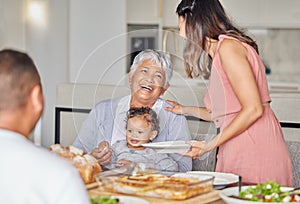 Family, grandmother and baby with food at the dining room or kitchen table for mothers day. Happy mother, father and