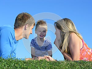 Family on grass faces