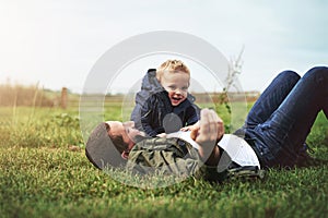 Family, grass and father with baby in park for bonding, playing and laugh together outdoors. Nature, field and happy dad