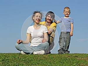 Family on grass sit