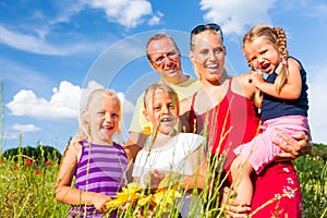 Family in grass in summer