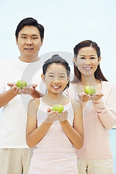 Family with green apples. Conceptual image