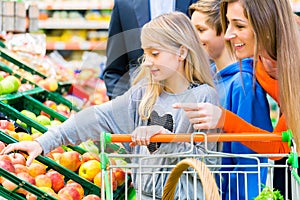 Family grocery shopping in hypermarket