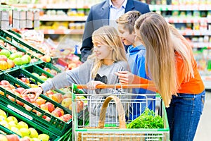 Family grocery shopping in hypermarket