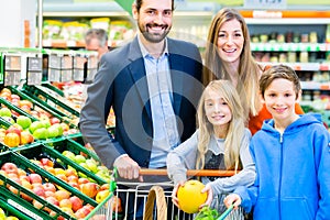 Family grocery shopping in hypermarket