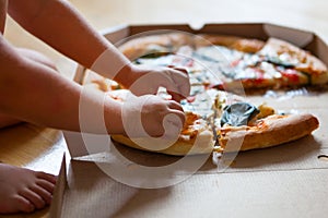 Family group dinner. Hands taking slices of pizza with box. Friends Happiness Enjoying Eating Concept