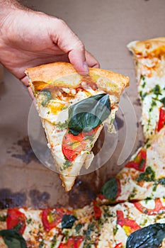 Family group dinner. Hands taking slices of pizza with box. Friends Happiness Enjoying Eating Concept