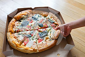 Family group dinner. Hands taking slices of pizza with box. Friends Happiness Enjoying Eating Concept