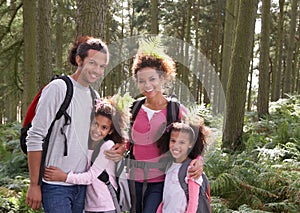 Family Group Hiking In Woods Together