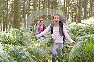 Family Group Hiking In Woods Together