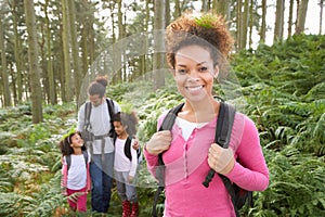 Family Group Hiking In Woods Together