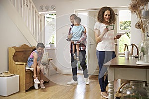 Family In Hallway Returning Home Together