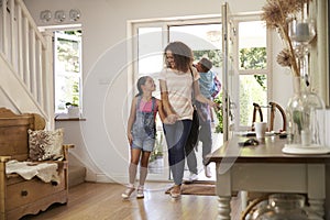 Family In Hallway Returning Home Together photo