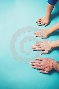 Family hands on blue background