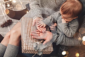 Family hands holding a christmas gift box. Merry Christmas and Happy New Year holidays, xmas theme