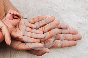 Family hands are stacking hands under the baby& x27;s hand