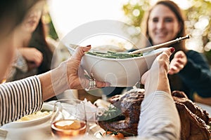 Family hands, thanksgiving food and green beans salad in holiday celebration, social lunch or dinner gathering in house