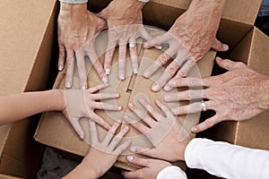 Family Hands Unpacking Boxes Moving House