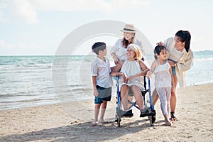 Family happily chatted with Grandma on the beach wheelchair