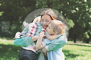 Family happiness! Happy mother tenderly embracing his two sons photo