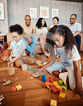 Family, happy and children playing with blocks for education, learning and curiosity. Living room, playful and kids with